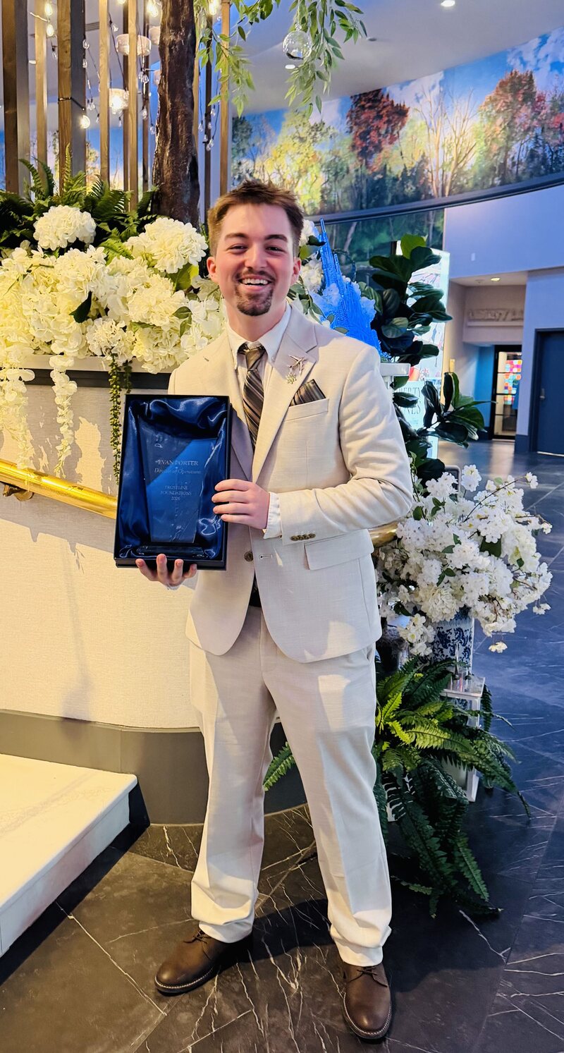 A Frostline Foundations professional receiving a recognition award